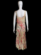 Load image into Gallery viewer, A sleeveless tiered maxi dress with a pink and red floral print on a beige base, displayed on a white mannequin.
