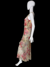 Load image into Gallery viewer, A sleeveless tiered maxi dress with a pink and red floral print on a beige base, displayed on a white mannequin.

