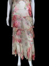 Load image into Gallery viewer, A sleeveless tiered maxi dress with a pink and red floral print on a beige base, displayed on a white mannequin.
