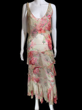 Load image into Gallery viewer, A sleeveless tiered maxi dress with a pink and red floral print on a beige base, displayed on a white mannequin.
