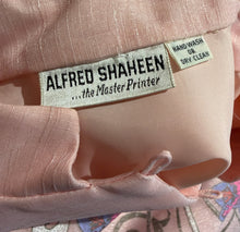 Load image into Gallery viewer, Close-up of a pale pink fabric garment showing a sewn-in label that reads 'ALFRED SHAHEEN .
