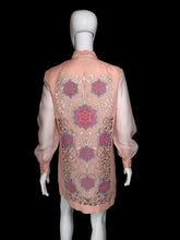 Load image into Gallery viewer, A pink embroidered tunic dress shown on a white mannequin. The dress features long sheer sleeves, a mandarin collar, and intricate floral and scroll embroidery in pink, purple, and gold.
