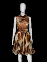 Load image into Gallery viewer, A sleeveless fit-and-flare dress displayed on a white mannequin. The dress features a brown and beige abstract leaf print on a sheer mesh fabric, with a matching waist sash and bow detail on the front.
