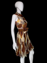 Load image into Gallery viewer, A sleeveless fit-and-flare dress displayed on a white mannequin. The dress features a brown and beige abstract leaf print on a sheer mesh fabric, with a matching waist sash and bow detail on the front.
