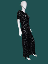 Load image into Gallery viewer, A black floral print silk burn out maxi dress displayed on a white mannequin.
