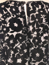 Load image into Gallery viewer, A close up of black floral print silk burn out fabric 
