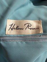 Load image into Gallery viewer, A close-up of a teal fabric garment featuring a beige satin brand label with the name 'Helen Rose' in black script.
