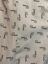 Load image into Gallery viewer, Close-up of a light beige fabric with an allover black Pucci logo print.
