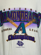 Load image into Gallery viewer, A close-up of a white vintage baseball graphic T-shirt featuring the Arizona Diamondbacks National League Champions design with crossed bats, a large 'A' logo, and a small World Series 2001 patch graphic.
