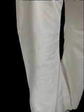 Load image into Gallery viewer, A close-up of the pant leg showing visible stains and faint handwritten markings on the surface.
