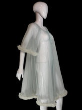 Load image into Gallery viewer, A sheer, light blue tulle mesh robe with swiss dots all over, a tie-neck detail and ruffled trim, displayed on a white mannequin.
