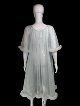 Load image into Gallery viewer, A sheer, light blue tulle mesh robe with swiss dots all over, a tie-neck detail and ruffled trim, displayed on a white mannequin.
