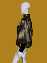 Load image into Gallery viewer, A metallic gold pleated blouse with black long sleeves and a high mock neck, shown on a white mannequin.
