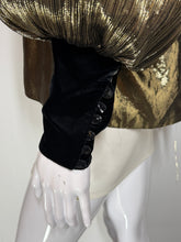 Load image into Gallery viewer, Close-up of a mannequin wearing a metallic gold blouse with a black sleeve featuring a row of black buttons.
