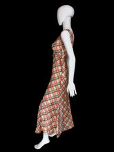 Load image into Gallery viewer, A 1930's sleeveless V-neck midi dress with a diagonal plaid pattern in red and black on a beige base on a white mannequin.
