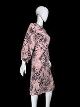 Load image into Gallery viewer, A pink long-sleeve dress with a black floral toile print displayed on a white mannequin.
