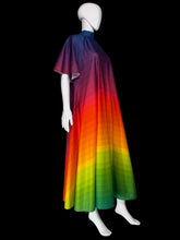 Load image into Gallery viewer, A rainbow-striped dress displayed on a white mannequin. The dress features a gradient pattern transitioning from dark blue and purple at the top, through red and orange, to yellow, green, and light green at the bottom.
