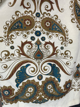 Load image into Gallery viewer, A close-up of ornate paisley and scroll pattern in brown, gold, and blue.
