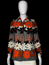 Load image into Gallery viewer, A long-sleeve button-up shirt with a bold retro floral and striped pattern in orange, black, white, and gray, displayed on a white mannequin.
