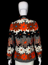 Load image into Gallery viewer, A retro polyester knit top with a bold 1970s floral and geometric pattern, displayed on a white mannequin.

