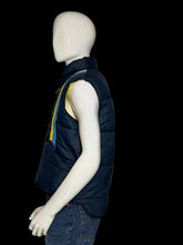 Load image into Gallery viewer, A navy blue puffer vest with yellow and blue striped detailing on the chest, displayed on a white mannequin wearing blue jeans.
