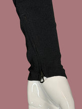 Load image into Gallery viewer, Close-up of a black sleeve or cuff with a visible front zipper, displayed on a glossy white mannequin arm.
