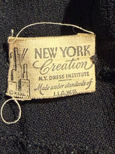 Load image into Gallery viewer, A close-up of a vintage tan woven label sewn onto black fabric, reading 'NEW YORK Creation'
