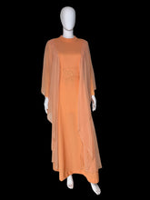 Load image into Gallery viewer, An orange vintage maxi dress with sheer draping sleeves displayed on a white mannequin.
