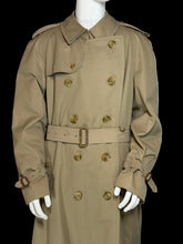 Load image into Gallery viewer, A close up of a classic Burberry double-breasted trench coat in khaki beige, shown on a white mannequin. The coat features a belted waist, shoulder epaulets, and button closures.
