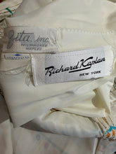 Load image into Gallery viewer, Close-up of a white or cream satin garment showing two interior brand labels: a Richard Kaplan New York label and a Zita Inc. Milwaukee Naples label.
