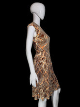 Load image into Gallery viewer, A sleeveless fit-and-flare dress with a geometric diamond pattern in orange, brown, and beige, displayed on a white mannequin.
