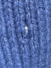 Load image into Gallery viewer, A close-up of a blue ribbed knit fabric with a small hole.
