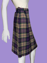 Load image into Gallery viewer, A purple, green, and cream plaid skirt displayed on a white mannequin. 
