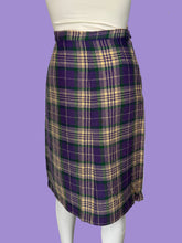Load image into Gallery viewer, A purple, green, and cream plaid skirt displayed on a white mannequin. 
