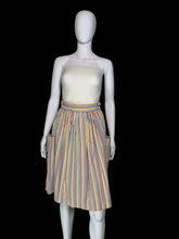 Load image into Gallery viewer, A vintage striped skirt shown on a white mannequin. The skirt features vertical stripes in yellow, blue, orange, and red on a white base, with side pockets.
