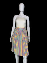Load image into Gallery viewer, A vintage striped skirt shown on a white mannequin. The skirt features vertical stripes in yellow, blue, orange, and red on a white base, with side pockets.
