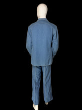 Load image into Gallery viewer, A back view of a blue denim two-piece set consisting of a long-sleeve button-front shirt and matching pants, displayed on a white mannequin.
