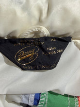 Load image into Gallery viewer, Close-up of a black fabric brand label with gold embroidery reading 'Sherry' and '100% nylon water repellent' on white satin-like material.
