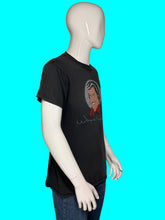 Load image into Gallery viewer, A black graphic t-shirt featuring a cartoon illustration of Wayne Newton and his signature, displayed on a white mannequin wearing blue jeans.
