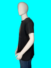 Load image into Gallery viewer, A black short-sleeve graphic t-shirt displayed on a white mannequin torso, paired with blue jeans.
