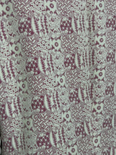 Load image into Gallery viewer, A close-up of a patterned fabric featuring a repeating design in dusty mauve and off-white.
