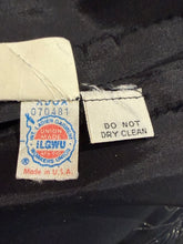 Load image into Gallery viewer, Close-up of a black garment's interior labels, showing a vintageunion label and a 'DO NOT DRY CLEAN' tag.
