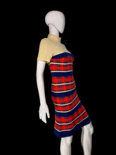 Load image into Gallery viewer, A short-sleeve mock-neck knit dress displayed on a white mannequin. The dress features a solid pale yellow upper section and a red, navy blue, and cream plaid patterned lower section.
