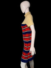 Load image into Gallery viewer, A short-sleeve mock-neck knit dress displayed on a white mannequin. The dress features a solid pale yellow upper section and a red, navy blue, and cream plaid patterned lower section.

