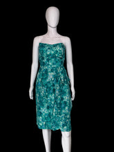 Load image into Gallery viewer, A strapless knee-length dress with a green and teal floral pattern, displayed on a white mannequin.

