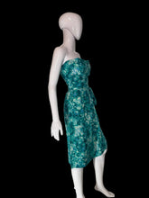 Load image into Gallery viewer, A strapless knee-length dress with a green and teal floral pattern, displayed on a white mannequin.
