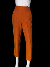 Load image into Gallery viewer, Bright orange cropped trousers displayed on a white mannequin
