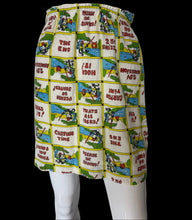 Load image into Gallery viewer, A vintage-style high-waisted mini skirt with a colorful cartoon comic-book patchwork print, displayed on a white mannequin torso.
