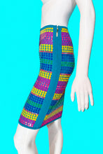 Load image into Gallery viewer, A colorful striped skirt displayed on a white mannequin from the side, featuring horizontal bands of yellow, blue, green, and magenta sequins with a teal border.
