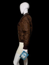 Load image into Gallery viewer, A brown nylon bomber jacket displayed on a white mannequin, shown from a side profile view.

